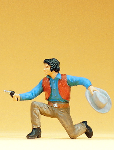 Cowboy kniend mit Revolver